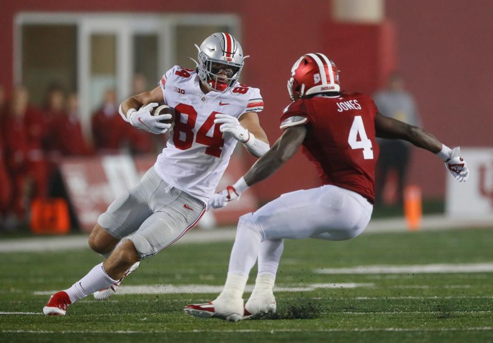 Ohio State Buckeyes tight end Joe Royer (84) runs past Indiana Hoosiers linebacker Cam Jones (4) during the fourth quarter of the NCAA football game at Memorial Stadium in Bloomington, Ind. on Saturday, Oct. 23, 2021. Ohio State won 54-7.
