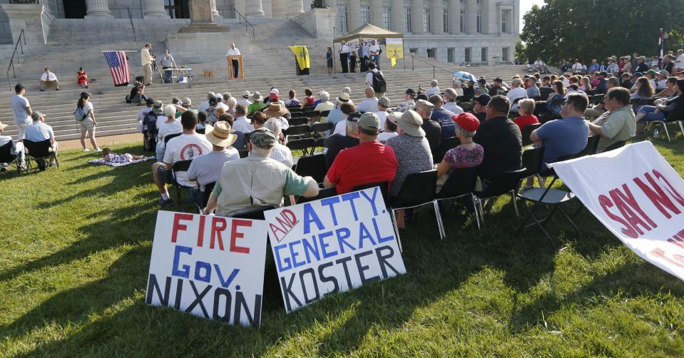 FILE - In a Wednesday, Sept. 11, 2013 file photo, people gather for a rally to override Gov. Jay Nixon's veto of a gun bill on the south lawn of the Missouri State Capital in Jefferson City, Mo. Having failed in an earlier effort to bar federal agents from enforcing gun regulations in Missouri, conservative lawmakers are trying a new tack in 2014: banding together with other like-minded states to defy certain federal laws at the same time. (AP Photo/Orlin Wagner, File)