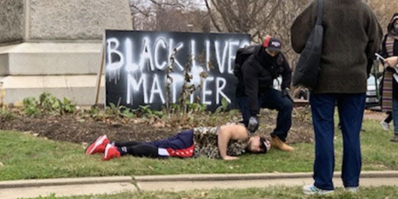 Investigators discovered photos of Samuel Fontanez Rodriguez and putting his knee on his friend's neck in front of a Black Lives Matter sign.