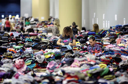 Volunteers sort donated clothes at a convention centre for Caribbean refugees whose homes were destroyed by Hurricane Irma, in San Juan, Puerto Rico September 14, 2017. REUTERS/Alvin Baez