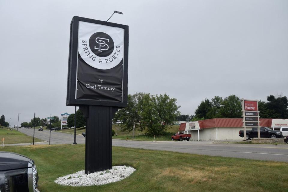 The temporary sign for the new restaurant Spring and Porter is displayed on Spring Street in front of the restaurant.