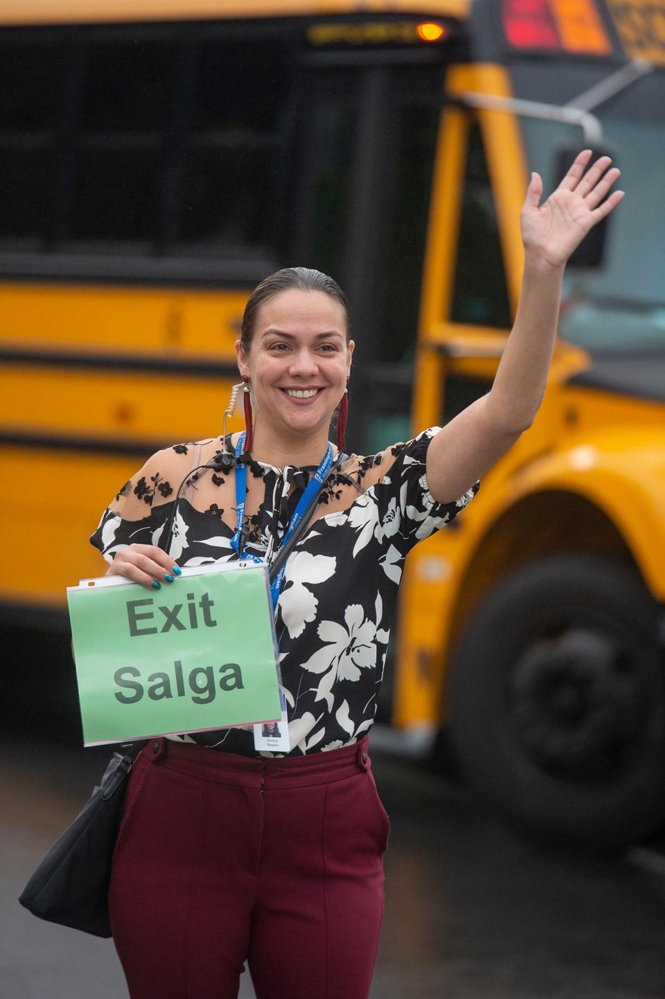 Brophy Elementary School Principal Jessica Mandes directs drop off traffic on the first day of school in Framingham, Aug. 30, 2023. Mandes is leaving to become director of multilingual education in Worcester.