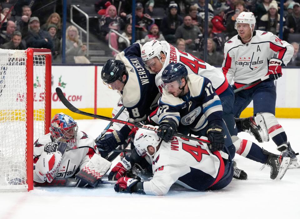Dec. 201, 2023; Columbus, Ohio, USA; 
Washington Capitals goaltender Charlie Lindgren (79) makes a save despite a pileup in front of the net during the third period of a hockey game against the Columbus Blue Jackets at Nationwide Arena on Thursday.