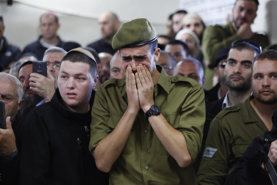 Soldiers and friends of Israeli soldier Yosef Cohen mourn during his funeral in Jerusalem, Friday, Dec. 14, 2018. Cohen was one of two Israeli soldiers killed by Palestinian gunman in the West Bank Thursday. (AP Photo/Ariel Schalit)