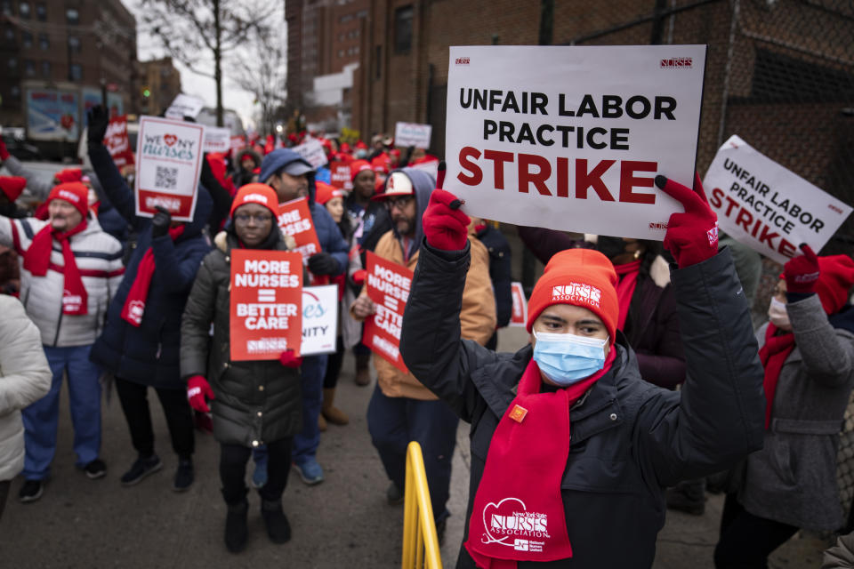 Protestors march on the streets around Montefiore Medical Center during a nursing strike, Wednesday, Jan. 11, 2023, in the Bronx borough of New York. A nursing strike that has disrupted patient care at two of New York City's largest hospitals has entered its third day. (AP Photo/John Minchillo)