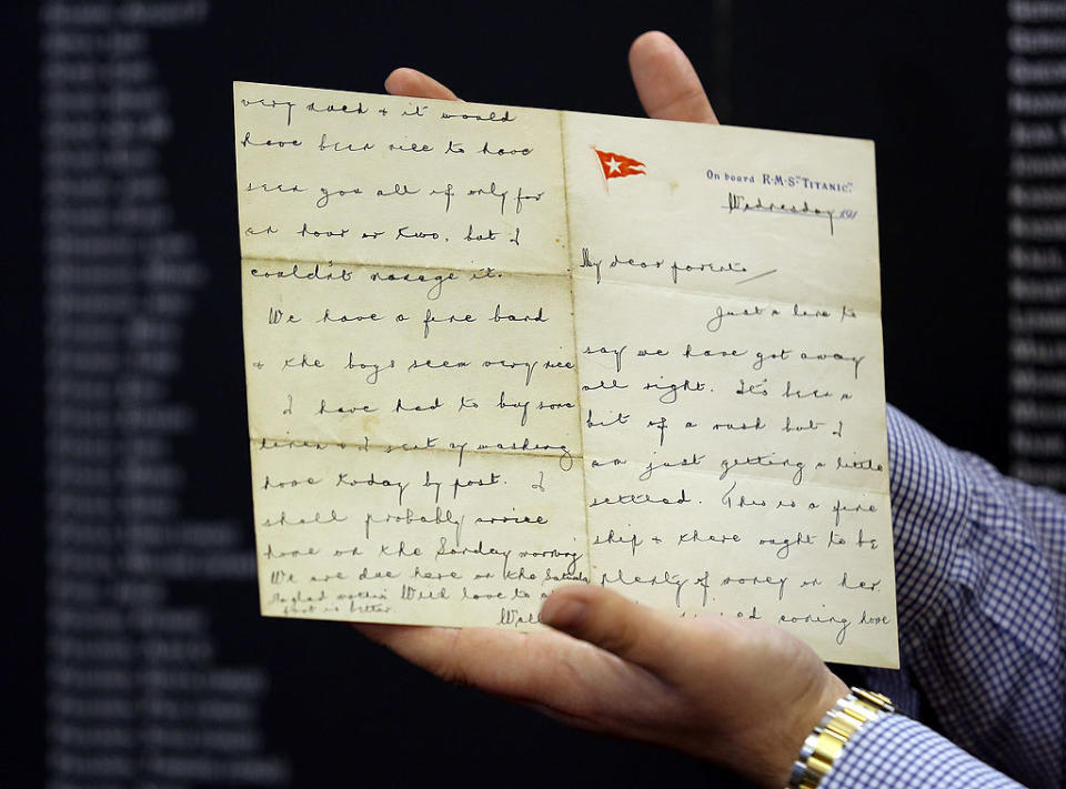 An old letter written in cursive being displayed