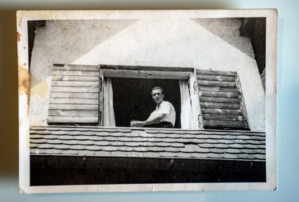 David Wolnerman sits in a windowsill while waiting to get immigration papers to resettle in America.