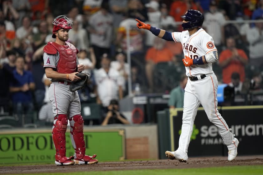 Houston Astros' Yuli Gurriel (10) celebrates after hitting a two-run home run as Los Angeles Angels catcher Drew Butera.