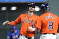 Houston Astros' Kyle Tucker high-fives third base coach Gary Pettis (8) after hitting a solo home run during the first inning of a baseball game against the Texas Rangers Friday, April 12, 2024, in Houston. (AP Photo/Kevin M. Cox)