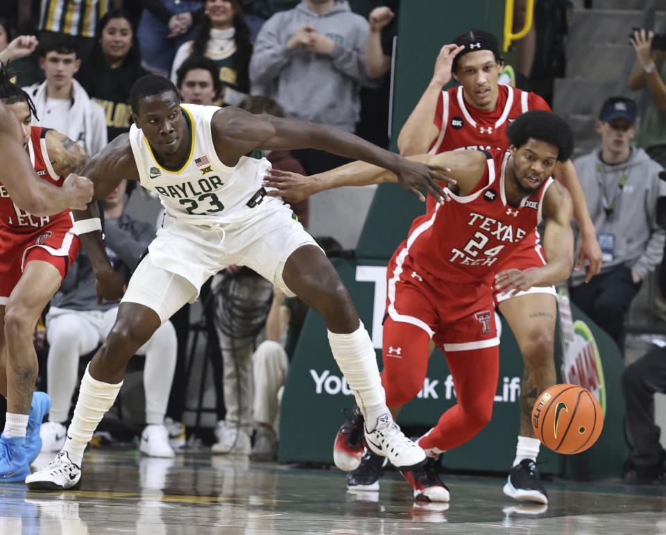 Texas Tech guard Kerwin Walton battles Baylor forward Jonathan Tchamwa Tchatchoua for a loose ball in the first half of an NCAA college basketball game, Tuesday, Feb. 6, 2024, in Waco, Texas. (Rod Aydelotte/Waco Tribune-Herald via AP)