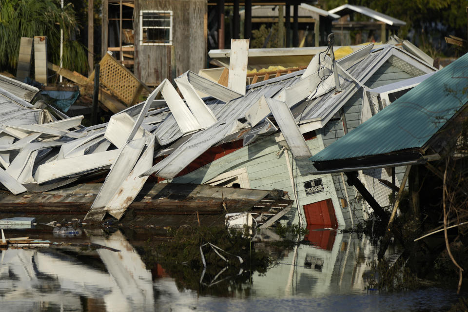 FILE - An unstilted home which came off its blocks sits partially submerged in a canal, in Horseshoe Beach, Fla., Friday, Sept. 1, 2023, two days after the passage of Hurricane Idalia. (AP Photo/Rebecca Blackwell, File)