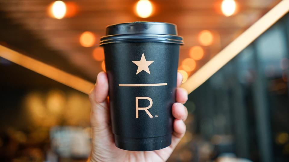 hand holding Starbucks Reserve coffee cup