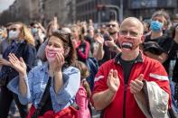 People attend a protest in front of the Serbian parliament in Belgrade