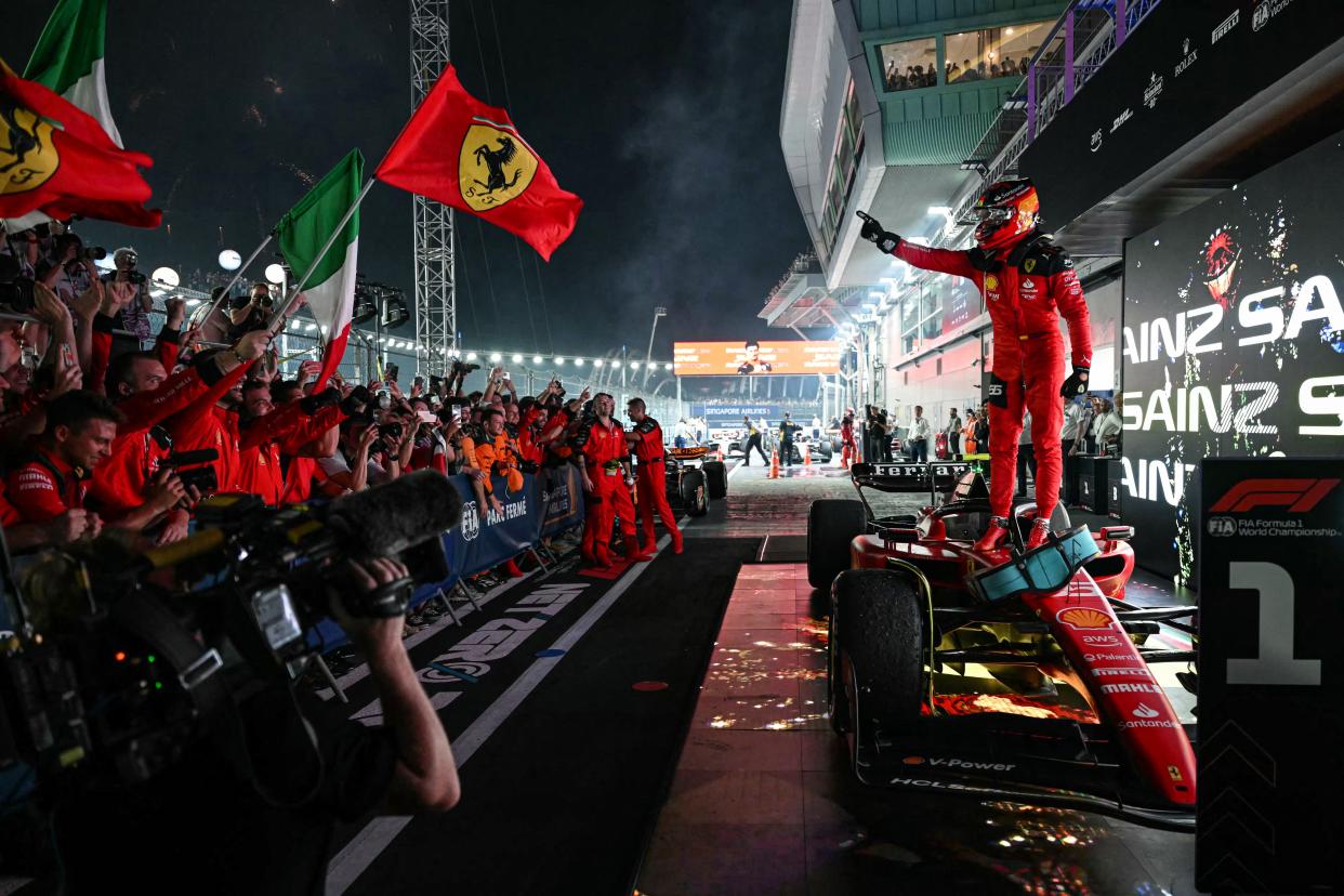 Ferrari's Spanish driver Carlos Sainz Jr celebrates winning the Singapore Formula One Grand Prix night race at the Marina Bay Street Circuit in Singapore on September 17, 2023. (Photo by MOHD RASFAN / AFP) (Photo by MOHD RASFAN/AFP via Getty Images)