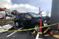 A vehicle is seen damaged after a powerful storm, in Nashville, Tenn. on Tuesday, March 3, 2020. Tornadoes ripped across Tennessee early Tuesday, shredding at least 40 buildings and killing many people. One of the twisters caused severe damage across downtown Nashville and leaving hundreds of people homeless. (AP Photo/Travis Loller)