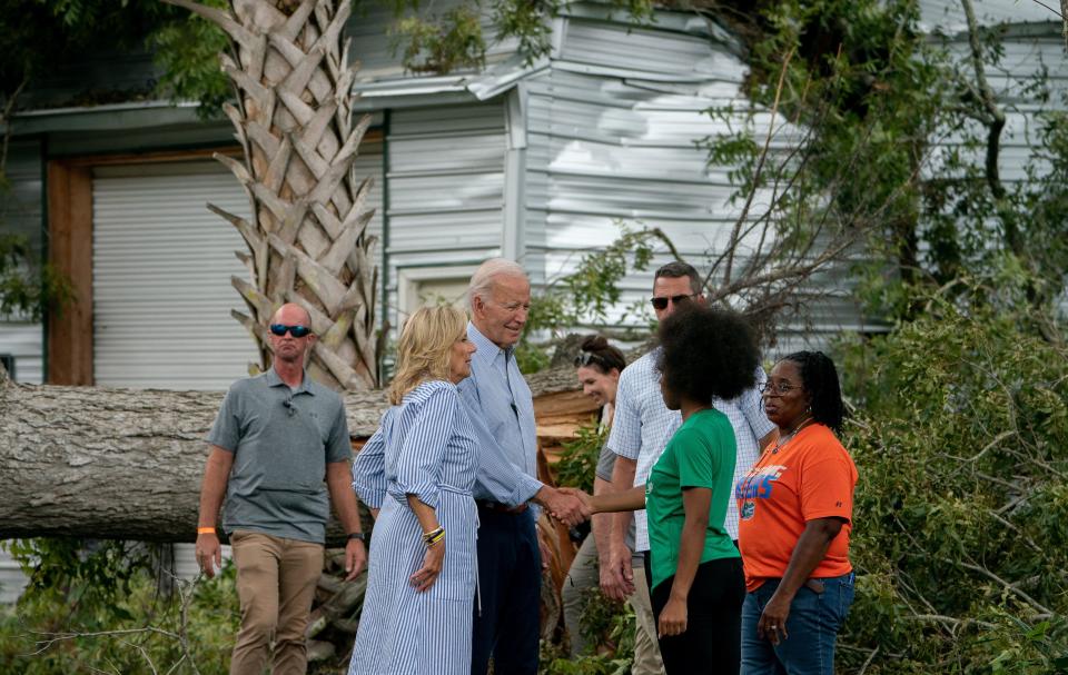 President Biden and First Lady Jill Biden speak to residents impacted by Hurricane Idalia, in front of fallen trees in Live Oak, Florida, on Sept. 2, 2023. / Credit: STEFANI REYNOLDS/AFP via Getty Images