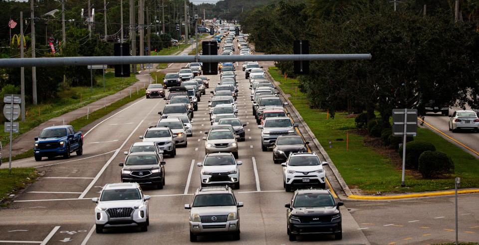 Traffic backs on Daniels Parkway in Fort Myers heading east towards I-75 on during afternoon rush hour on Monday, Nov. 13, 2023.