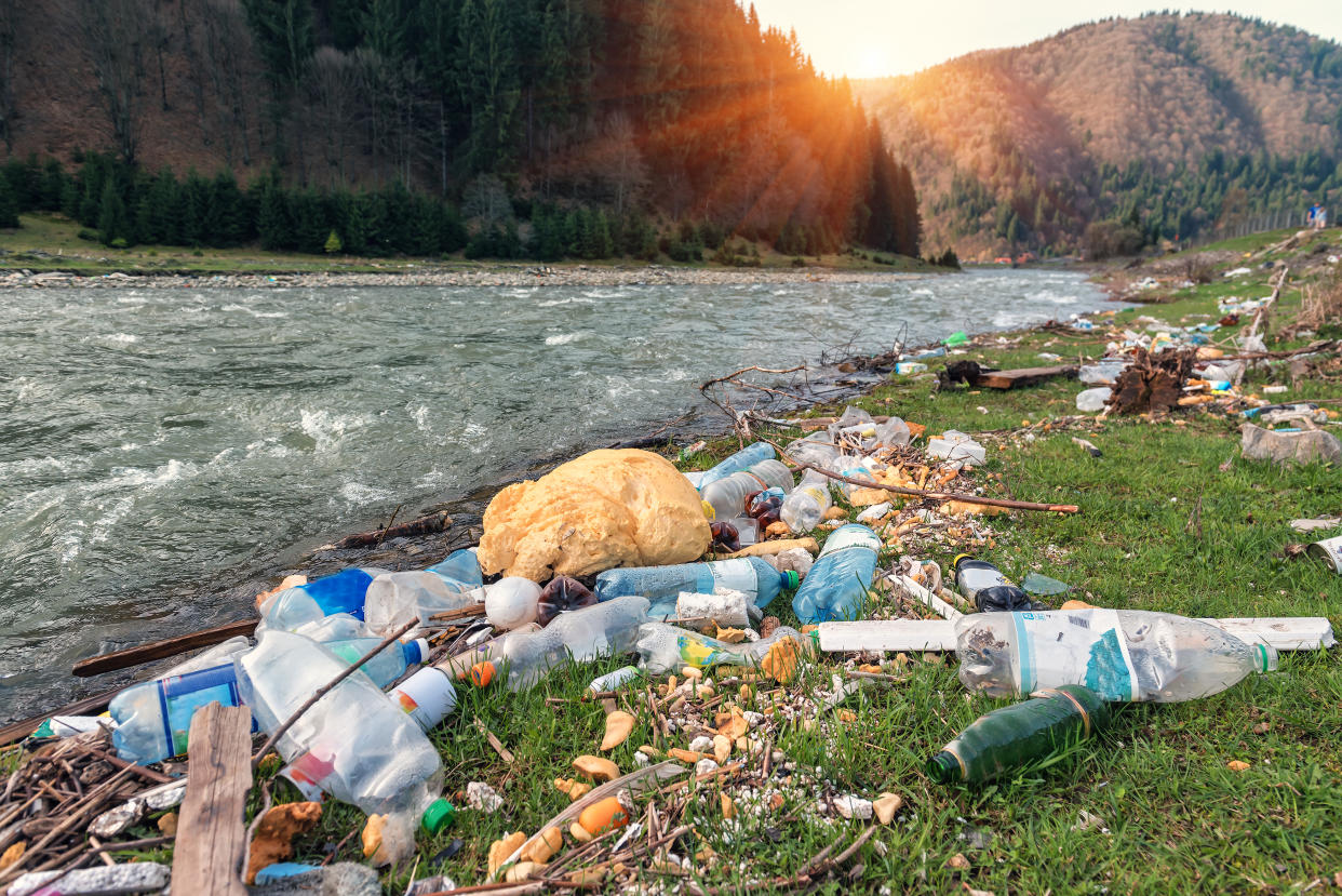 plastic garbage on the mountain river bank