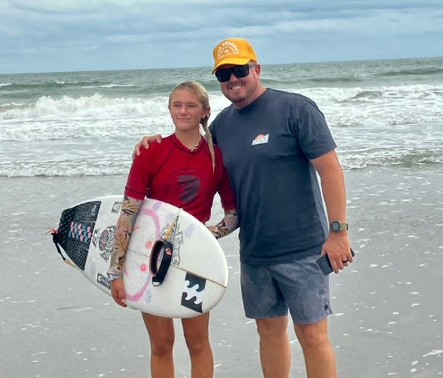 Indialantic's Daya McCart celebrates with her dad, Jaden, after winning her second straight Women's Pro title at this year's 38th Rich Salick National Kidney Foundation Surf Festival on Cocoa Beach. She won $1,200 and a medallion valued at $4,000.