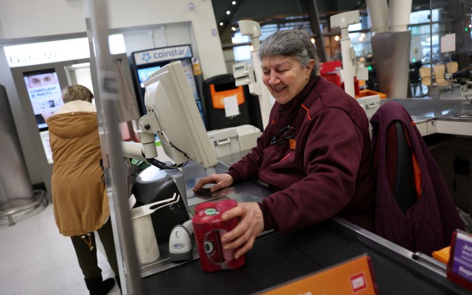 A cashier scans products inside a Sainsbury's in Richmond, West London, earlier this month
