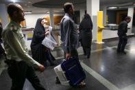 An electoral worker carries a ballot box after closing vote in a polling station in Tehran, Iran, May 19, 2017. TIMA via REUTERS