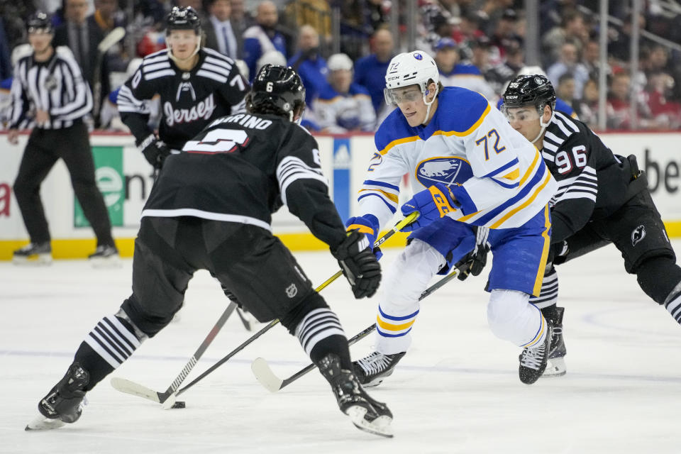 Buffalo Sabres center Tage Thompson (72) skates the puck against New Jersey Devils defenseman John Marino (6) during first period of an NHL hockey game, Tuesday, April 11, 2023, in Newark, N.J. (AP Photo/John Minchillo)