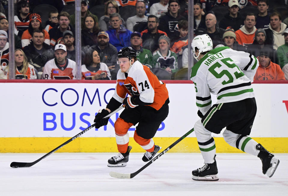 Philadelphia Flyers' Owen Tippett (74) skates the puck past Dallas Stars' Thomas Harley (55) during the second period of an NHL hockey game Thursday, Jan. 18, 2024, in Philadelphia. (AP Photo/Derik Hamilton)