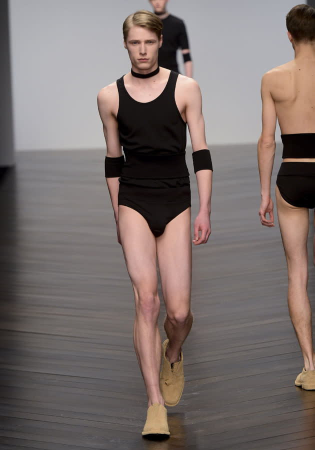 <b>London Fashion Week AW13: Central St Martins MA</b><br><br>A male model showed off an all-black look with a bizarre choker and sweat bands.<br><br>© Getty