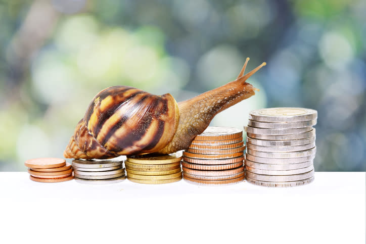 A snail moving up stacks of coins.