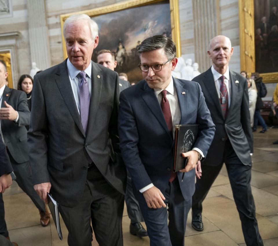 Speaker of the House Mike Johnson (R-LA) (center) walks through the Capitol Rotunda with Senators Ron Johnson (R-WI), left, and Rick Scott (R-FL)