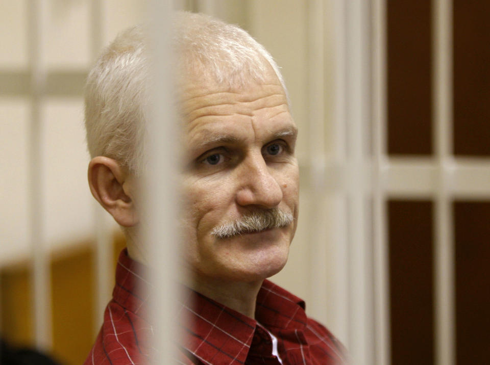 FILE - Ales Bialiatski, the head of Belarusian Vyasna rights group, stands in a defendants' cage during a court session in Minsk, Belarus, on Wednesday, Nov. 2, 2011. Belarusian pro-democracy activist Ales Bialiatski is one of several not able to receive their awards because they were imprisoned. Bialiatski shared the 2022 peace prize with human rights groups in Ukraine and Russia. (AP Photo/Sergei Grits, File)