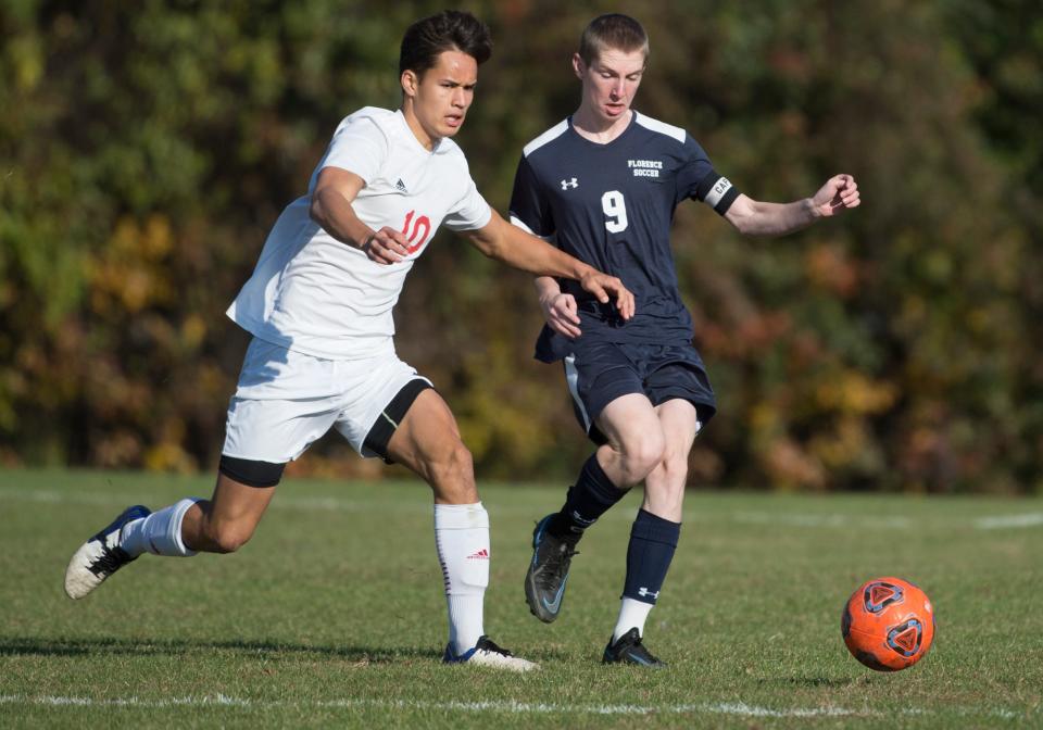 Haddon Township's Luke Chatten, left, and Florence's Kevin Krall battle for a loose ball during the state Group 1 semifinal boys soccer game played at Florence High School on Tuesday, November 16, 2021. Haddon Township defeated Florence, 3-1.