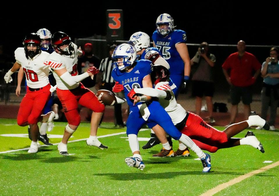 Liberty Lions linebacker Hudson Dunn (13) sacks O’Connor Eagles quarterback Mason Steele (12) during a game at O'Connor High in Phoenix on Sept. 1, 2023.