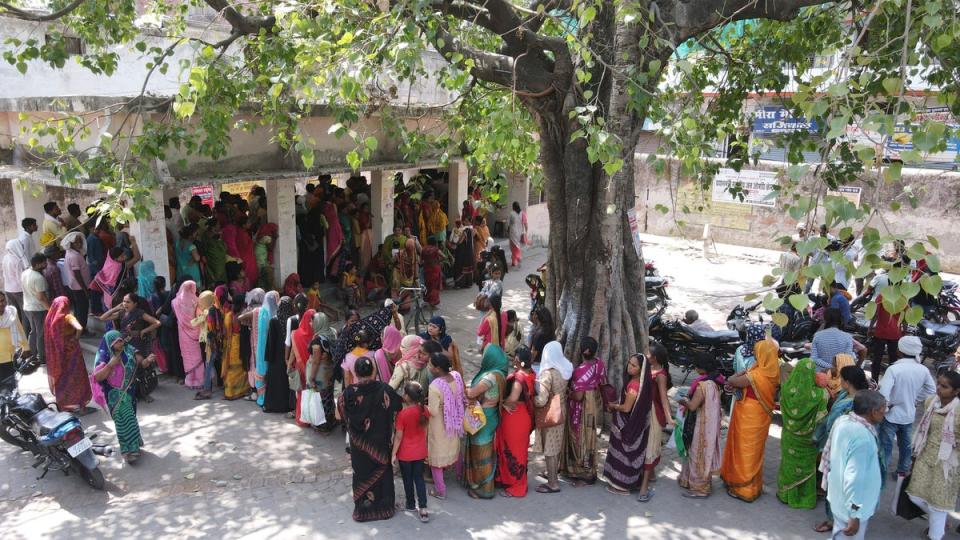 People stand in queue to register outside district hospital in Ballia, Uttar Pradesh state (AP)