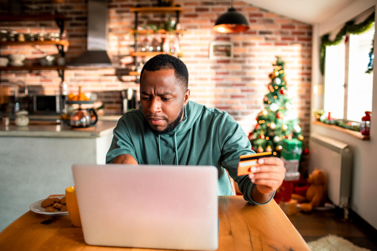 Close up of a young man using a laptop during Christmas