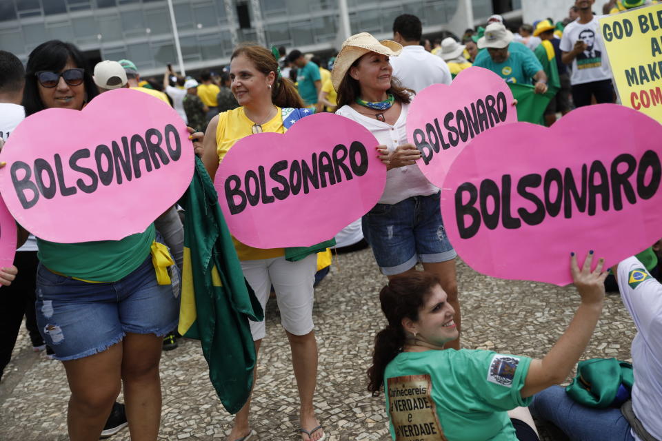 Locals show their support for Brazil's President Elect Jair Bolsonaro prior to his inauguration, in Brasilia, Brazil, Tuesday Jan. 1, 2019. (AP Photo/Silvia Izquierdo)