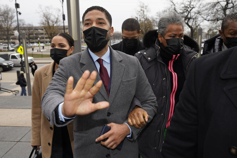 Actor Jussie Smollett asks photographers to move back as he arrives with his mother Janet, right, at the Leighton Criminal Courthouse for day three of his trial in Chicago on Wednesday, Dec. 1, 2021. Smollett is accused of lying to police when he reported he was the victim of a racist, anti-gay attack in downtown Chicago nearly three years ago. (AP Photo/Charles Rex Arbogast)