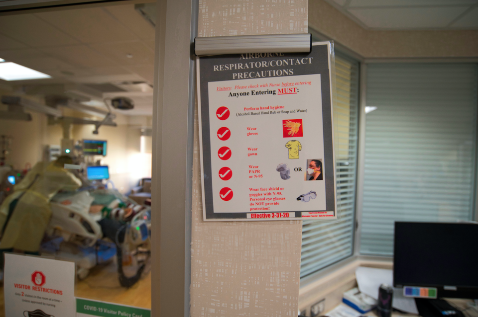 A sign telling health care staff what they must wear when entering a COVID-19 patient's room at Avera Health in Sioux Falls.