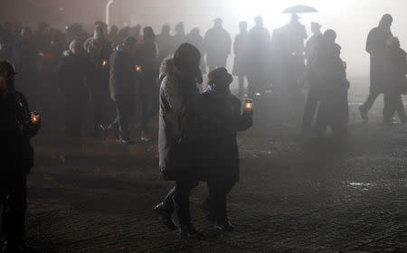 Survivors and guests light candles at the Monument to the Victims at the former Nazi German concentration and extermination camp Auschwitz II-Birkenau, during ceremonies marking the 73rd anniversary of the liberation of the camp and International Holocaust Victims Remembrance Day, near Oswiecim, Poland, January 27, 2018. REUTERS/Kacper Pempel