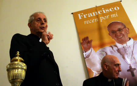 Buenos Aires' Archbishop Cardinal Mario Poli gestures next to Chascomus' Bishop Carlos Malfa and a portrait of Pope Francis after a news conference where they talked about the Vatican's declassification of documents related to Argentina's last military dictatorship in Buenos Aires, Argentina, October 25, 2016. REUTERS/Marcos Brindicci