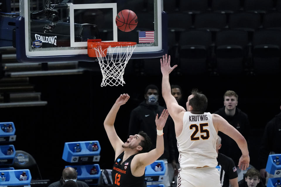 Oregon State center Roman Silva (12) drives to the basket ahead of Loyola Chicago center Cameron Krutwig (25) during the first half of a Sweet 16 game in the NCAA men's college basketball tournament at Bankers Life Fieldhouse, Saturday, March 27, 2021, in Indianapolis. (AP Photo/Jeff Roberson)