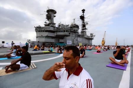 Members of Indian Navy perform yoga on the flight deck of INS Viraat, an Indian Navy's decommissioned aircraft carrier during International Yoga Day in Mumbai, June 21, 2017. REUTERS/Danish Siddiqui