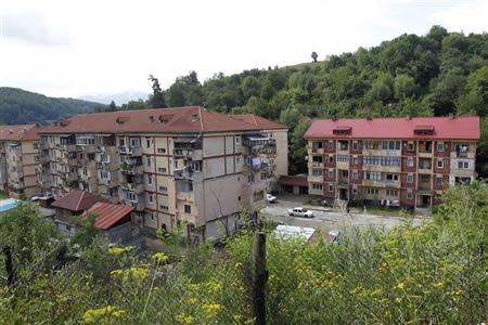 Apartment blocks are seen in Aninoasa, 330 km (202 miles) west of Bucharest July 31, 2013. If joining the European Union was supposed to lift Romania out of poverty, in Aninoasa, a town of 4,800 people in the mountainous Jiu Valley region, it has yet to work. Six years after Romania's accession to the EU, not only is Aninoasa still poor - it has also become the first town in Romania to file for insolvency. Picture taken July 31, 2013. REUTERS/Bogdan Cristel