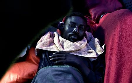 A migrant rests on the deck of MV Aquarius, a search and rescue ship run in partnership between SOS Mediterranee and Medecins Sans Frontieres on their way to Spain, June 13, 2018. Karpov / SOS Mediterranee/handout via REUTERS