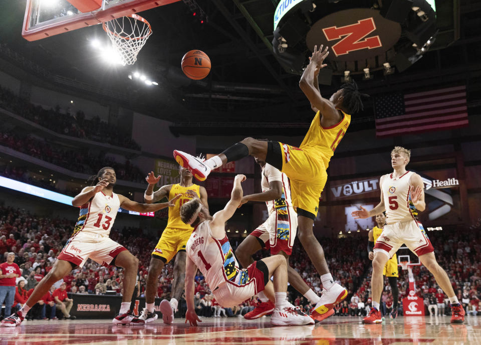 Nebraska's Sam Hoiberg (1) and Maryland's Hakim Hart (13) fall after colliding under the basket during overtime of an NCAA college basketball game Sunday, Feb. 19, 2023, in Lincoln, Neb. (AP Photo/Rebecca S. Gratz)