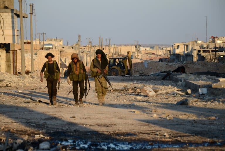 Turkish-backed Syrian rebels patrol through the town of al-Bab shortly after they captured it from the Islamic State (IS) group