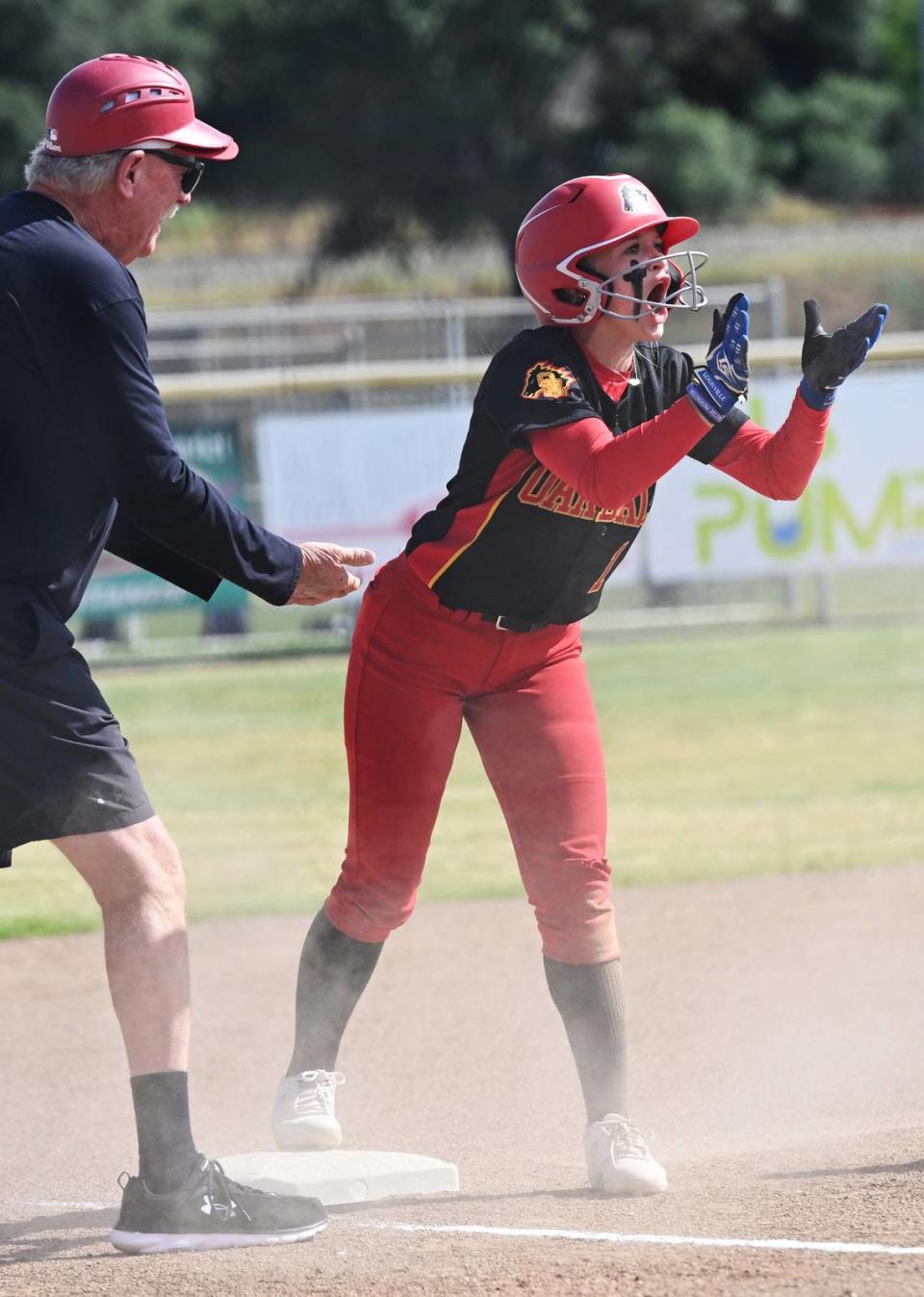 Oakdale’s Jayci Volonte calls out to her teammates after hitting a triple during the Valley Oak League game with Kimball in Oakdale, Calif., Thursday, May 4, 2023.