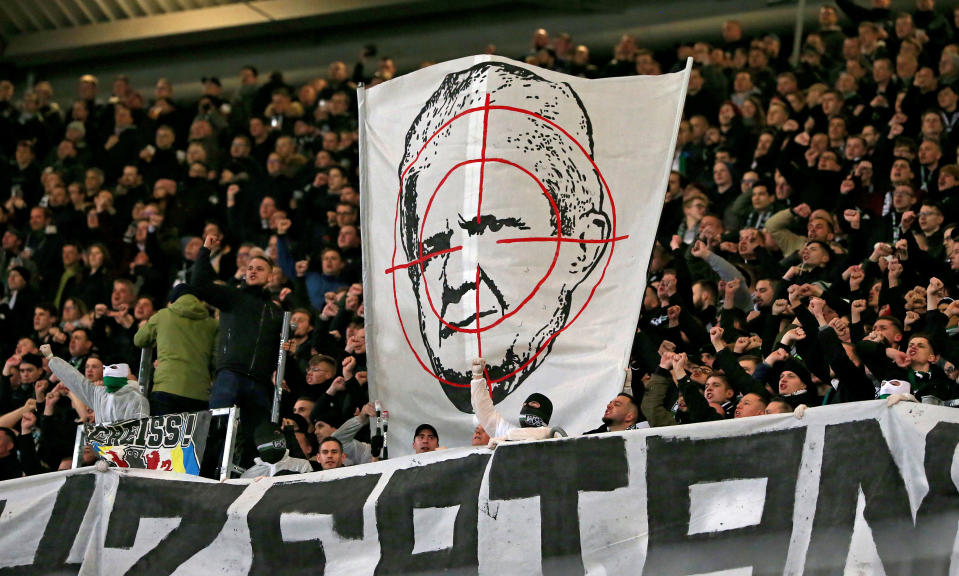 HANOVER, GERMANY - MARCH 02: Supporters of Hannover 96 hold up a sign showing Dietmar Hopp of Hoffenheim in a crosshair during the Second Bundesliga match between Hannover 96 and Holstein Kiel at HDI-Arena on March 02, 2020 in Hanover, Germany. (Photo by Cathrin Mueller/Bongarts/Getty Images)