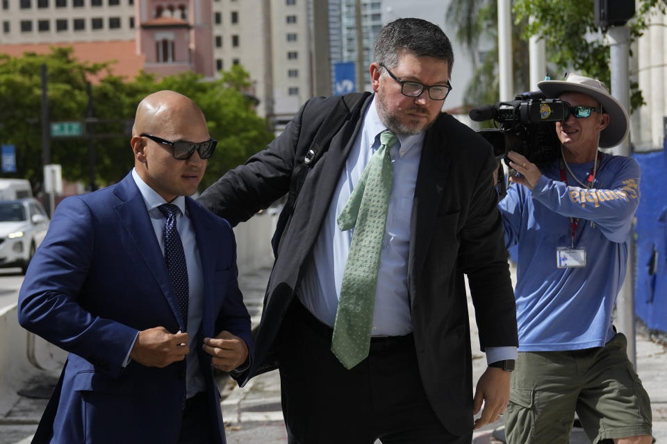 Walt Nauta, left, a valet to former President Donald Trump who is charged with helping the ex-president hide classified documents the Justice Department wanted back, arrives for his arraignment along with defense attorney Stanley Woodward, at the James Lawrence King Federal Justice Building in Miami, Thursday, July 6, 2023. (AP Photo/Rebecca Blackwell)