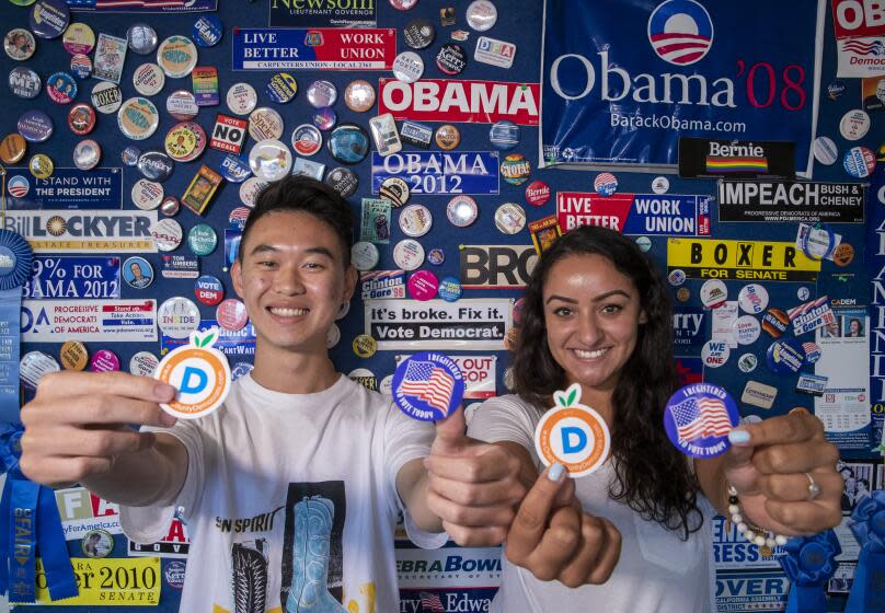 ORANGE, CALIF. -- MONDAY, AUGUST 5, 2019: Interns Lucas Uhm, left, and Andrea Madrid help register Orange County democratic voters at the Democratic Party of Orange County in Orange, Calif., on Aug. 5, 2019. (Allen J. Schaben / Los Angeles Times)